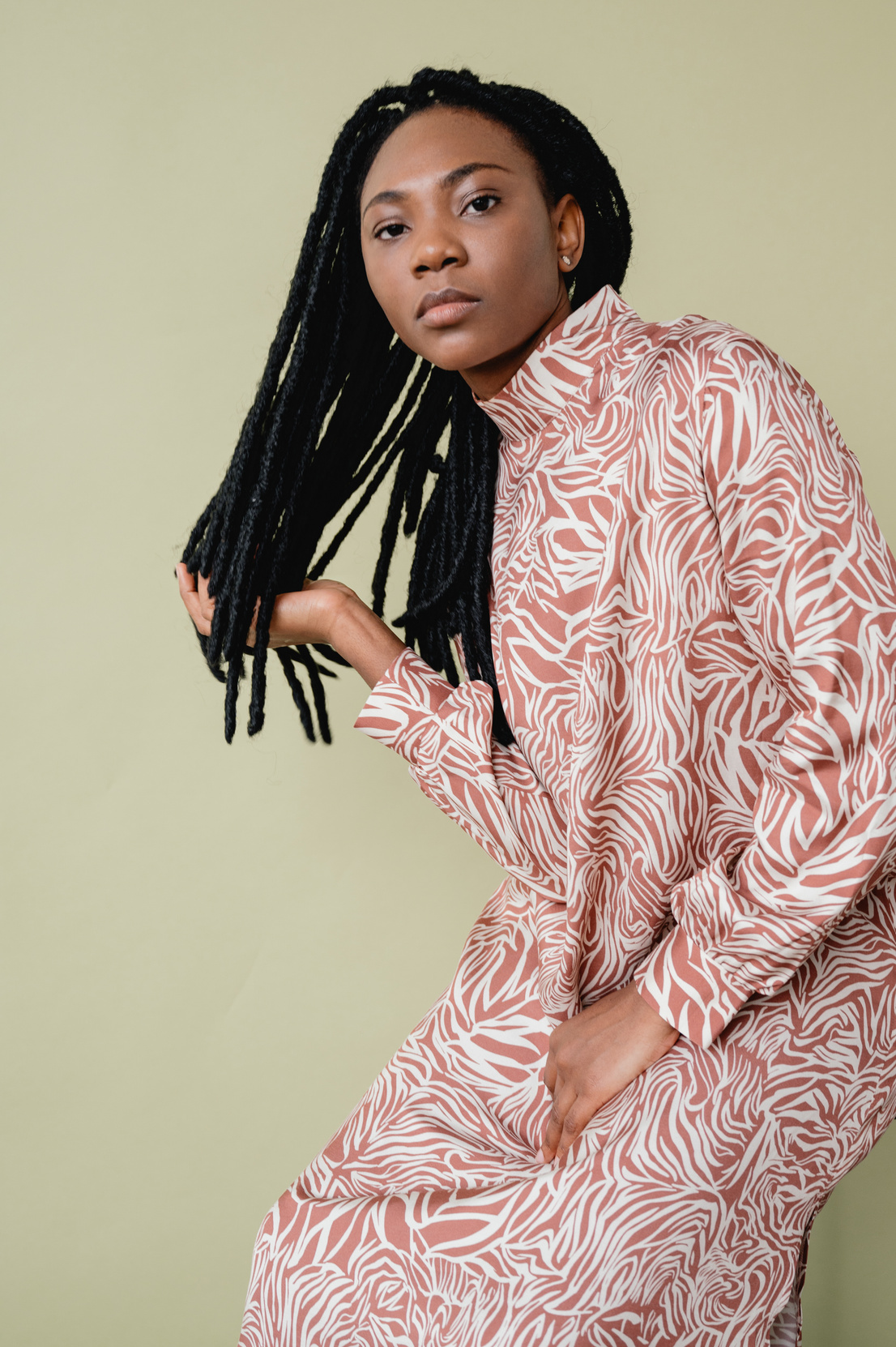 Young Woman in Animal Print Long Sleeve Dress with Dreadlocks